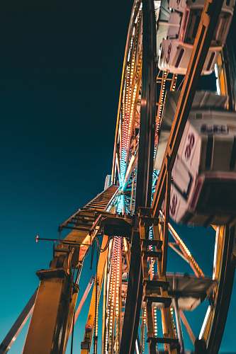 amusement park photo of multicolored Ferris Wheel construction crane
